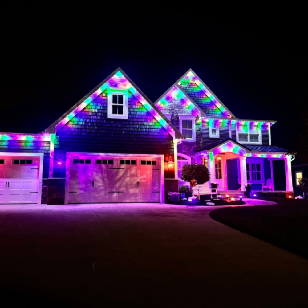 Permanent multicolor LED roofline lighting on Texas home at night