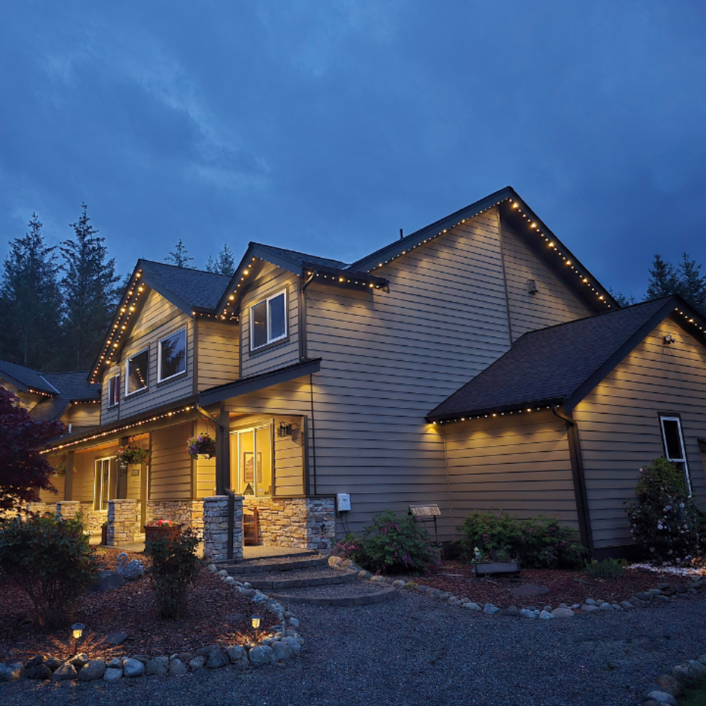 Dusk warm white roofline lighting on craftsman home